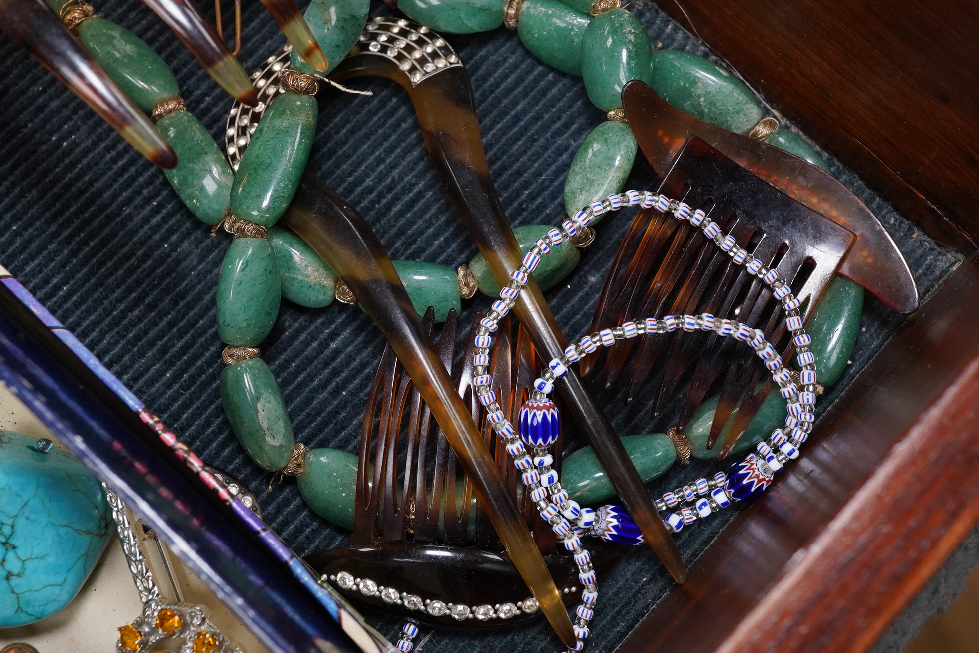 A group of assorted costume jewellery including an amber cigar holder and a Burberry gilt metal spaniel brooch